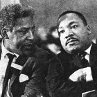 two men in black suits and ties sitting next to each other