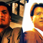 two men in suits standing next to another shoulder to shoulder