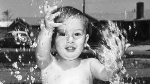 Baby splashing in a pool
