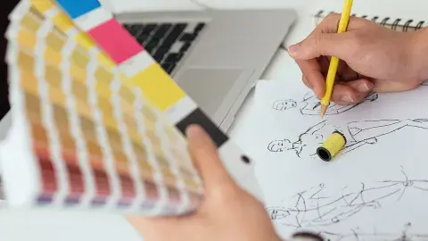 A close-up of a fashion drawing and color swatches