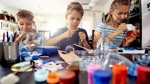 Family members making crafts with plastic and paper products