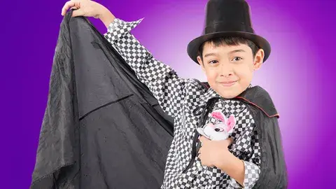 A child magician making a stuff bunny disappear