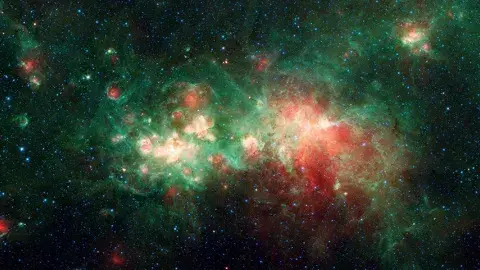 Spitzer Image of Star Factory W51 - The star-forming nebula W51 is one of the largest "star factories" in the Milky Way galaxy.