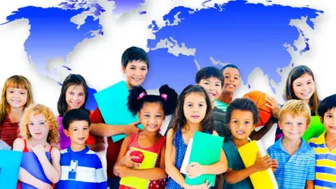 Group of kids with their books standing by a background of the world map