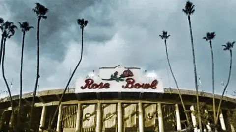 View of the Rose Bowl entrance flanked by tall palms on either sides