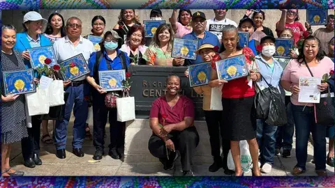 Dr. Hazly and participants pose in front of 5th Street entrance of Central Library
