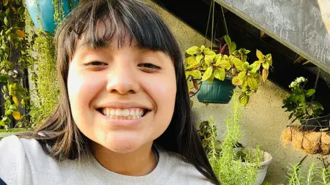 a smiling teen in a garden