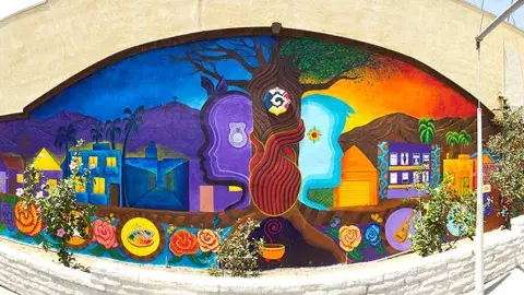 Tia Chucha's Cultural Center & Bookstore's mural depicting the tree of life, the masculine/feminine generating principles of the world, and the wholeness of self, community, earth, and spirit.