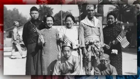 A group of Chinese motion picture extras after a Labor Day parade in Los Angeles. Eddie stands at the far left next to his wife, Jennie.