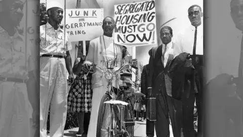 Wright travels on a bicycle to take part in march