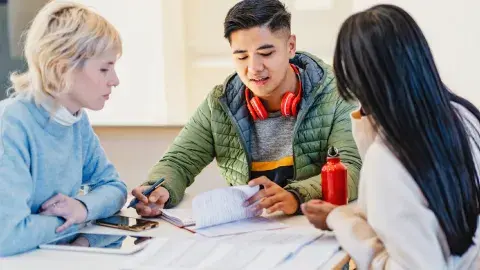 3 teens in a discussion about finances