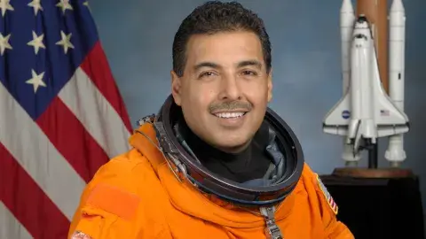 Astronaut Dr. Jose M. Hernandez in his orange spacesuit