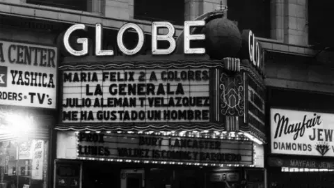The marquee of the Globe Theater advertises Spanish-language entertainment in the early 1970s.