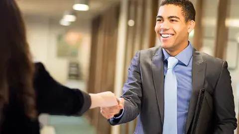 man shaking a hand of another business person after an interview
