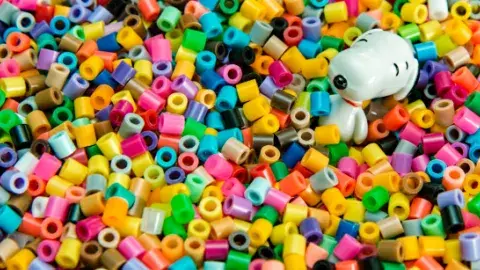 Colorful plastic beads with a cartoon dog among them