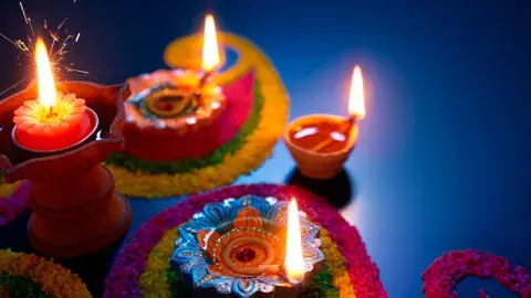 Celebrate Diwali with lighted candles in the colorful pots.