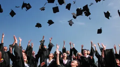 Graduates throwing caps in the air 