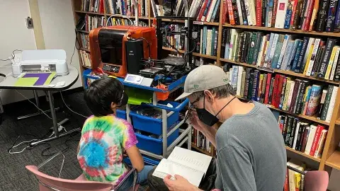 Father son sit by 3F printer