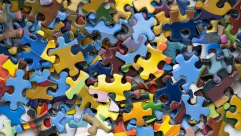 a pile of colorful jigsaw puzzle pieces