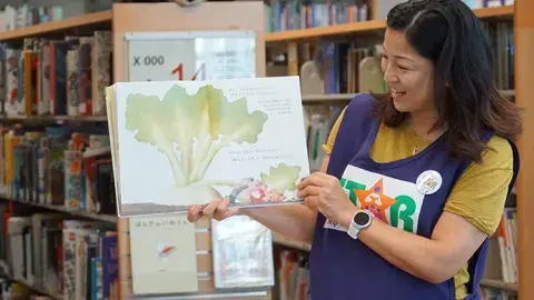star reader holding a book