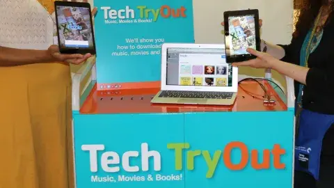 blue cart with black handle and white, green, and orange lettering