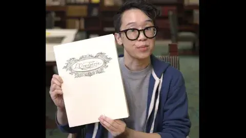 person holds up menu