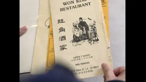 Close up of hands lifting a vintage menu