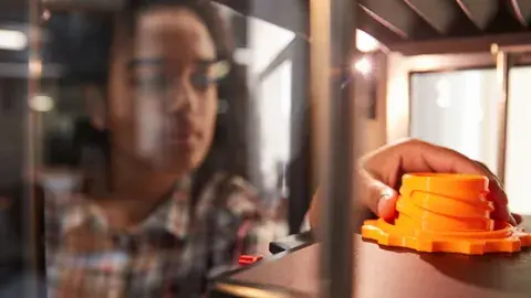 Kid looking at an object that was 3D printed.