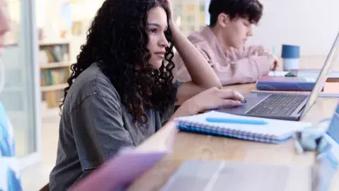  students studying and using laptops