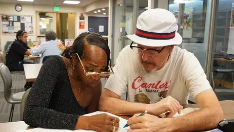 Tutor working with adult learner.