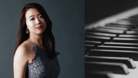 Pianist Xiao Chen next to a piano keyboard