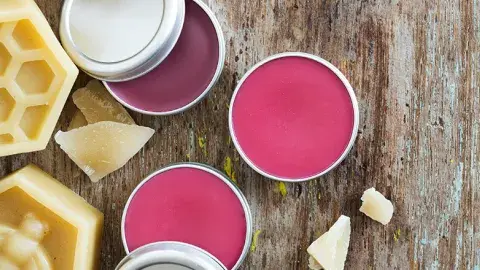 tins of pink lip balm and beeswax tablets