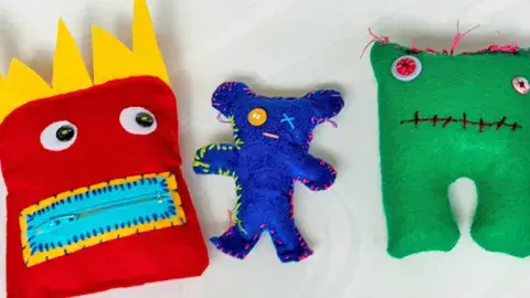 Brightly-colored, handmade fanciful figures made from felt and thread.