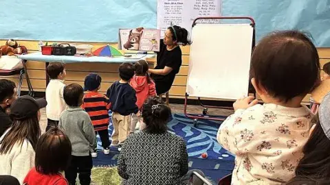 Children looking and listening to a story.