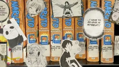 Manga books on shelf surrounded by DIY manga stickers.
