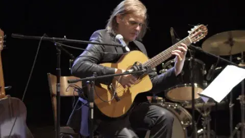 A man playing a guitar.