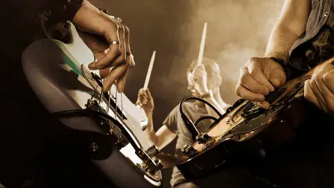 Closeup of a band playing musical instruments and performing live.