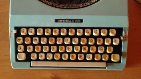 typewriter sits on a desk