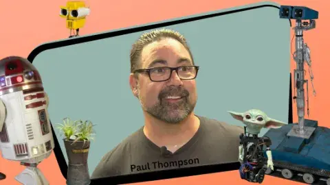 A man framed by two robots from entertainment. 
