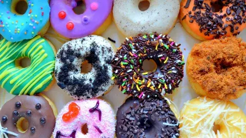 a dozen colorful donuts