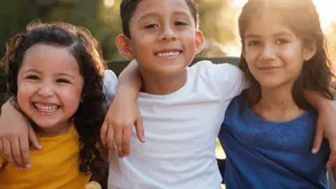 three children smiling