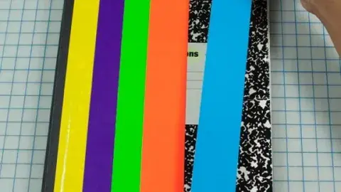 Image of a notebook being decorated with craft tape