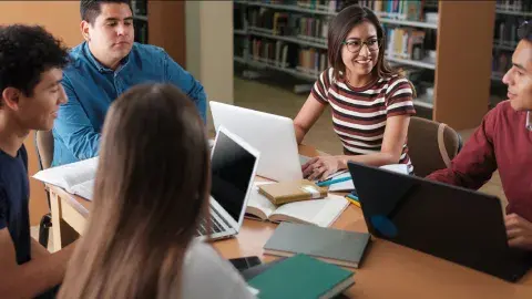 teens sitting around table talking