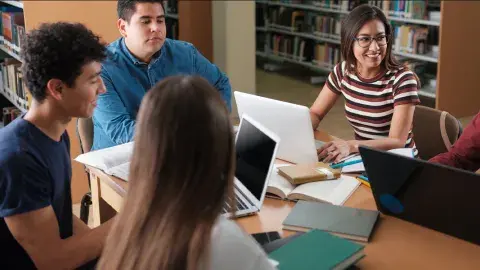 people sitting around table and talking
