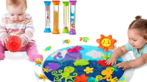 Picture of two toddlers playing with sensory items: a texture ball and a water pad