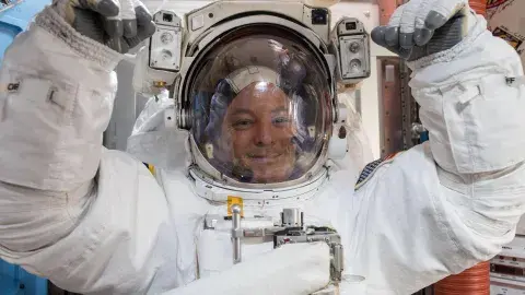 NASA astronaut Scott Tingle wears a U.S. spacesuit inside the Quest Airlock preparing for his first spacewalk