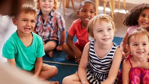 Kids sitting and listening to a story.