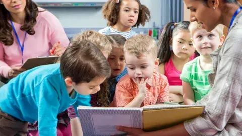 Children looking and listening to a story.