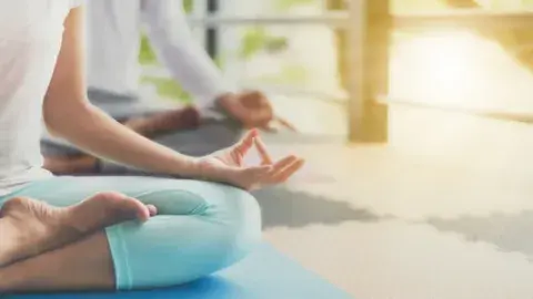 Photo of person in seated yoga position. 