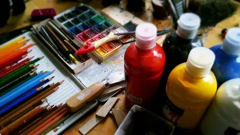 Various art supplies such as color pencils, watercolor, acrylic 